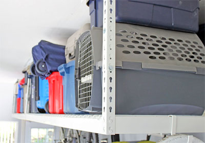 Boxes and Bins Stored in Overhead Ceiling Storage Rack in Garage